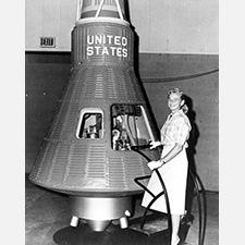 Jerrie Cobb with a Mercury capsule (credit - NASA / public domain)